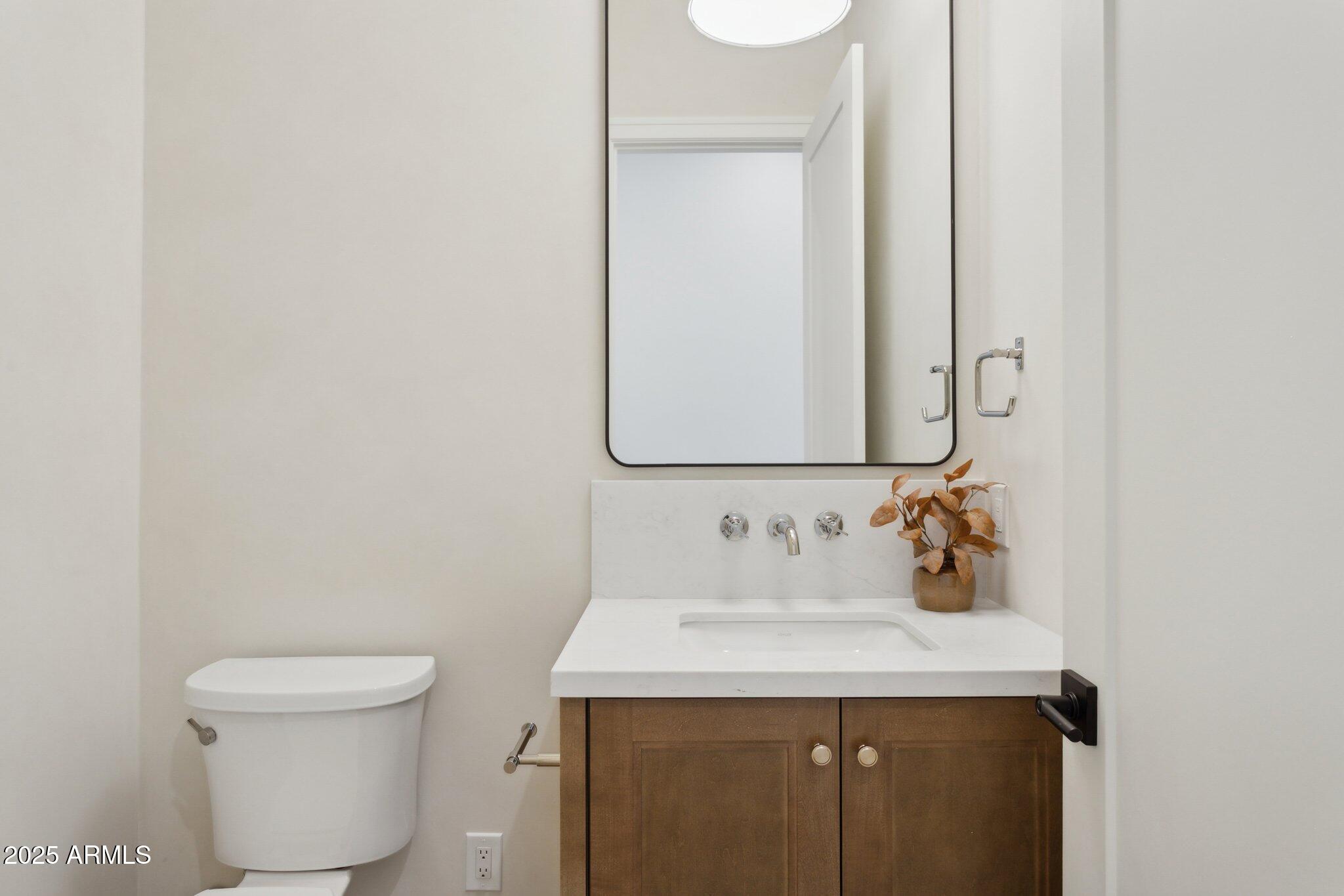 2942 North 47th Place Phoenix, AZ 85018 - Photo 25 of 40 a bathroom with a sink and a toilet