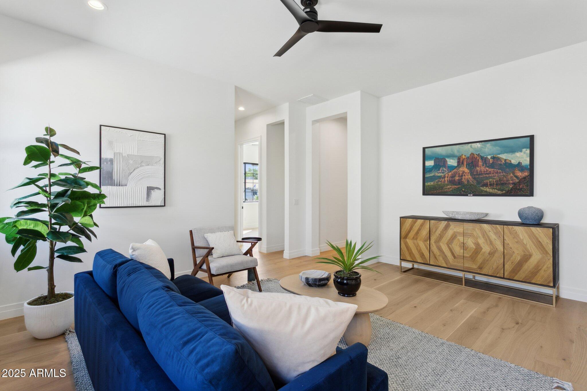 2942 North 47th Place Phoenix, AZ 85018 - Photo 26 of 40 a living room with furniture potted plant and wooden floor
