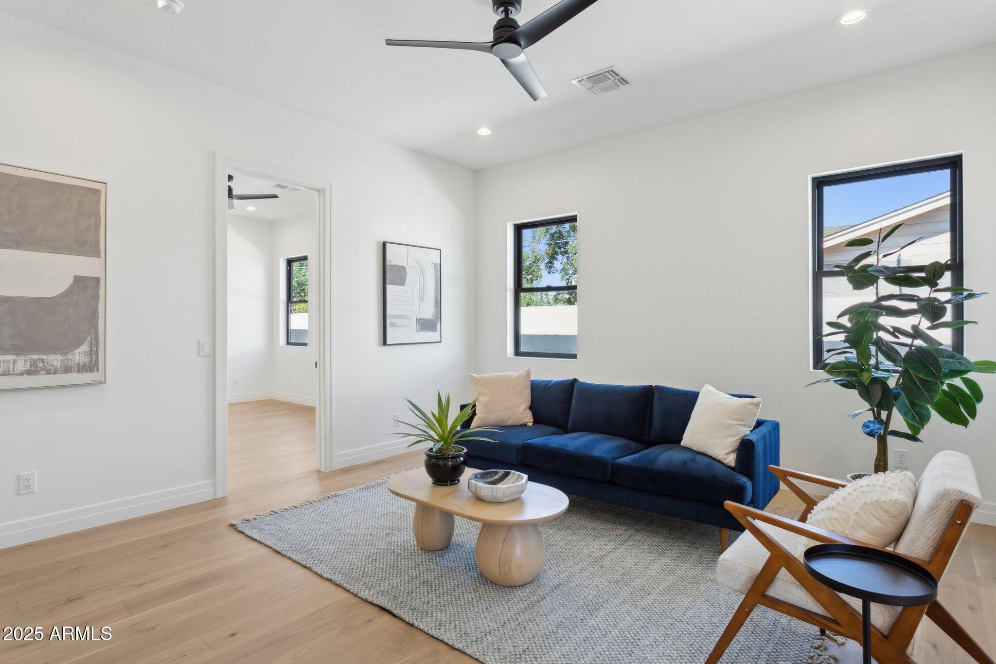 2942 North 47th Place Phoenix, AZ 85018 - Photo 27 of 40 a living room with furniture and a potted plant