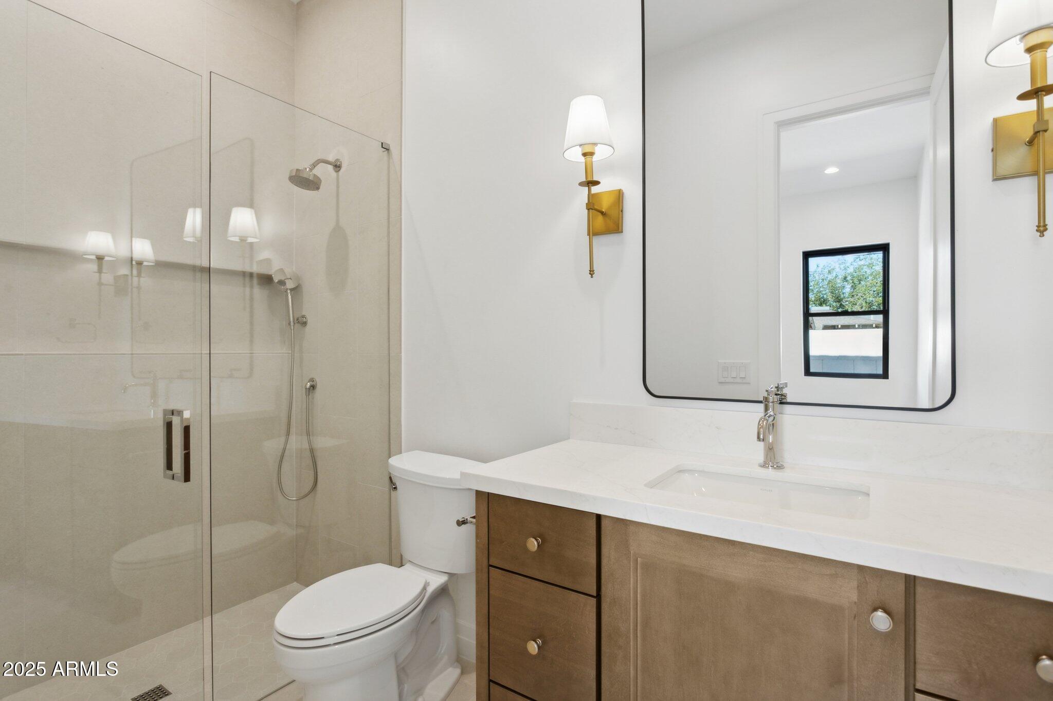2942 North 47th Place Phoenix, AZ 85018 - Photo 30 of 40 a bathroom with a sink a toilet and shower