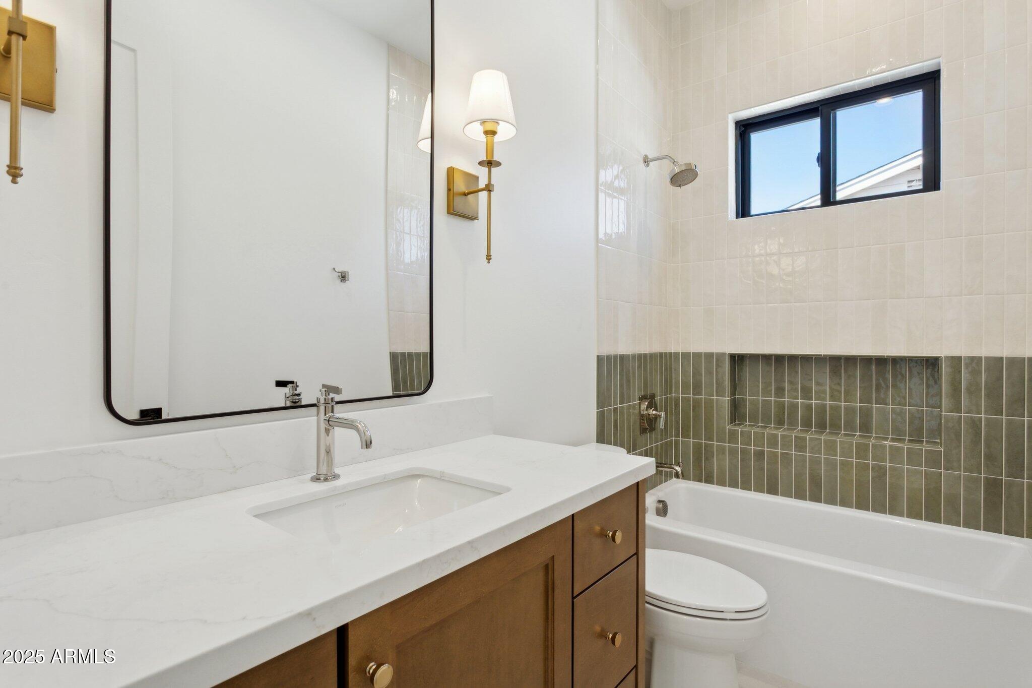 2942 North 47th Place Phoenix, AZ 85018 - Photo 35 of 40 a bathroom with a sink a toilet and shower