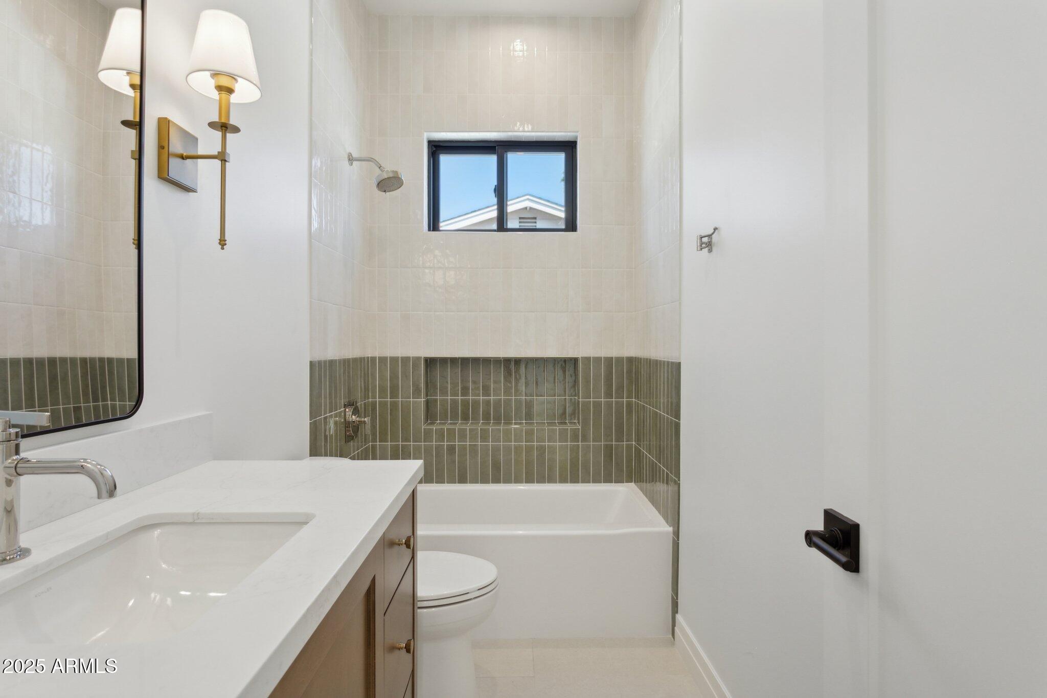 2942 North 47th Place Phoenix, AZ 85018 - Photo 36 of 40 a bathroom with a sink a toilet and shower