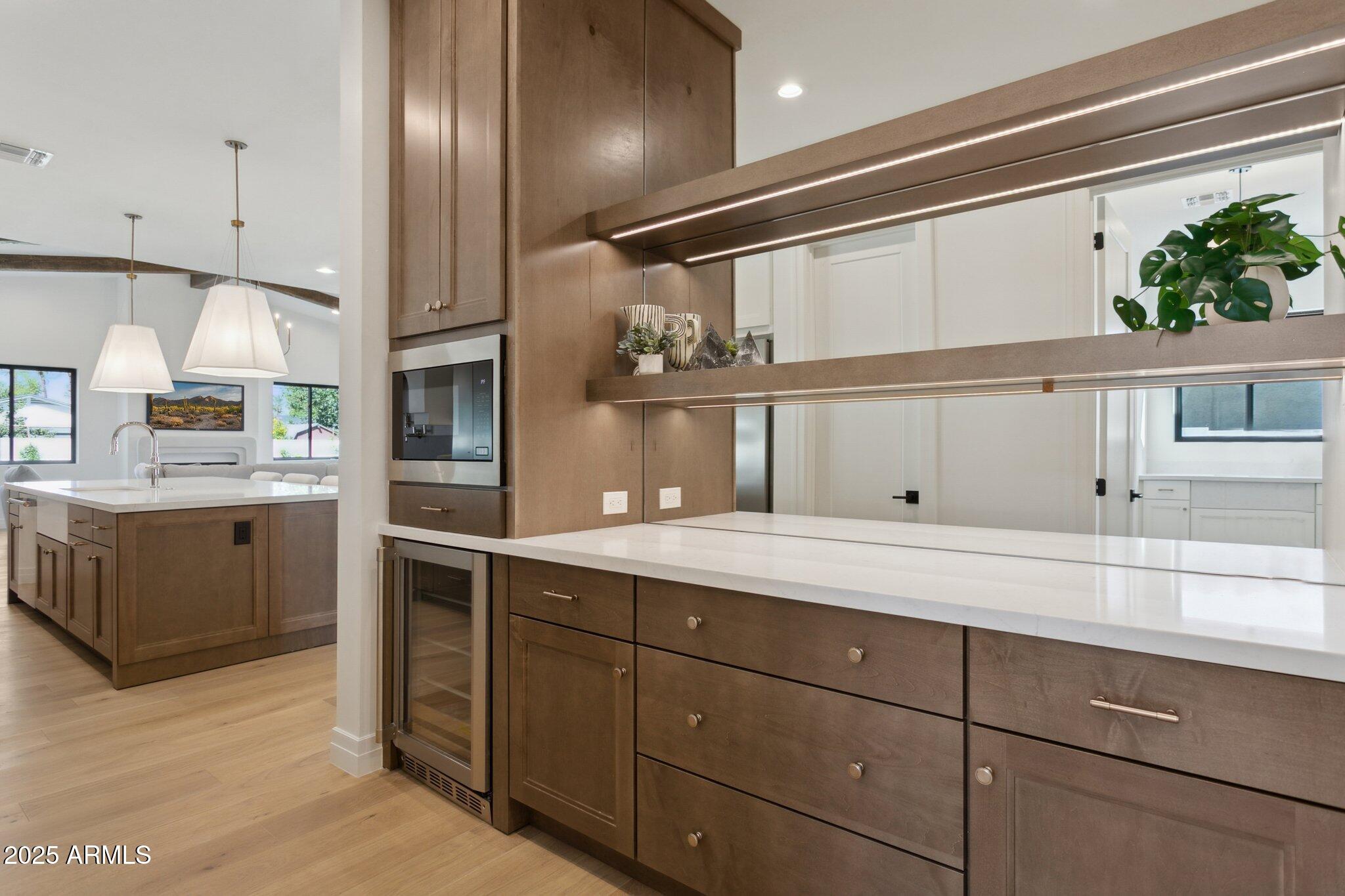2942 North 47th Place Phoenix, AZ 85018 - Photo 9 of 40 a kitchen with a sink stainless steel appliances and cabinets