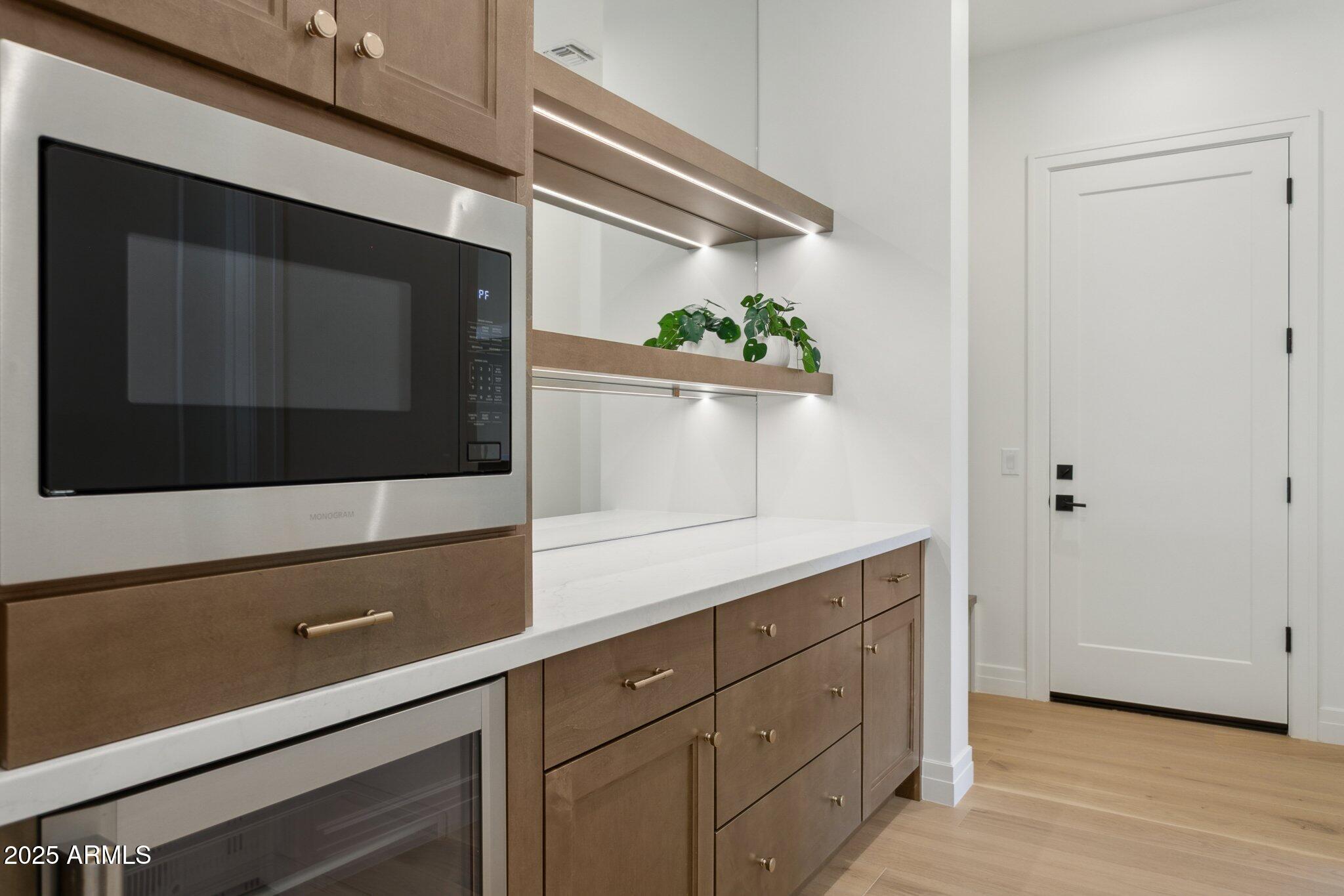2942 North 47th Place Phoenix, AZ 85018 - Photo 10 of 40 a utility room with cabinets and wooden floor