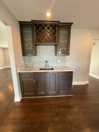 a bathroom with a granite countertop sink a mirror and shower