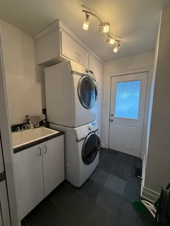 a utility room with sink dryer and washer