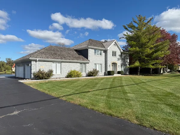 a house with huge green field in front of it