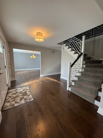 a view of an empty room and wooden floor