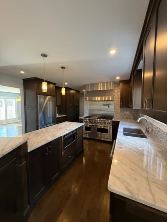 a large kitchen with stainless steel appliances