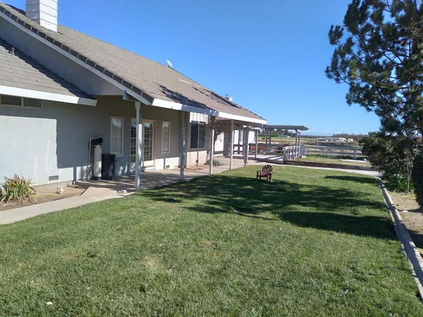 a front view of a house with a yard table and chairs