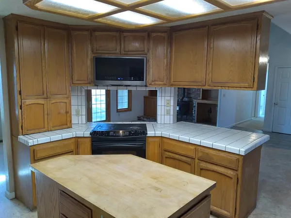 a kitchen with a stove and a kitchen island