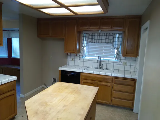 a kitchen with a sink and cabinets