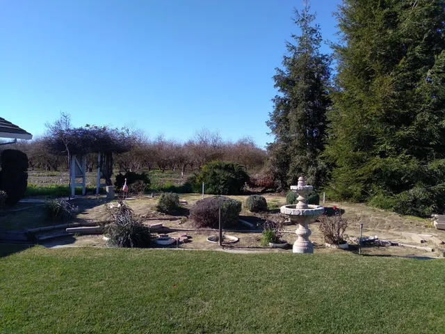 a view of a patio with table and chairs potted plants with wooden fence