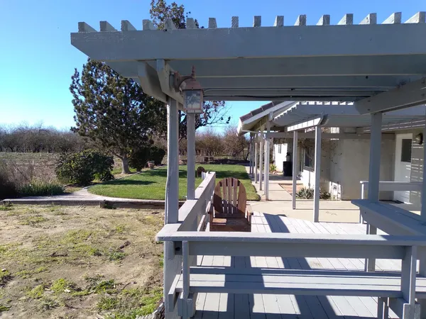 a view of a chairs and table in patio