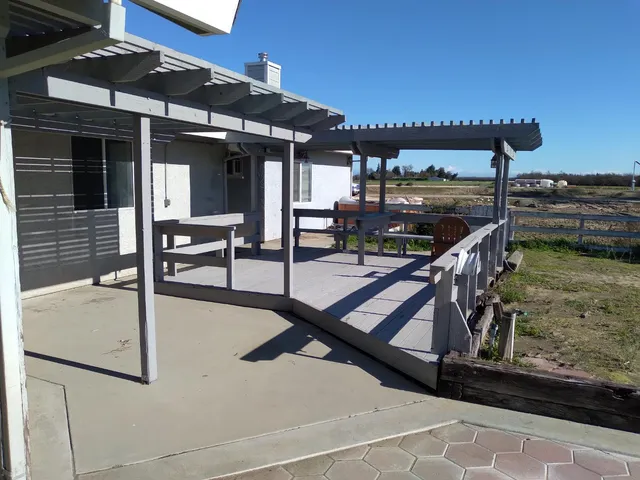 a view of a patio with table and chairs