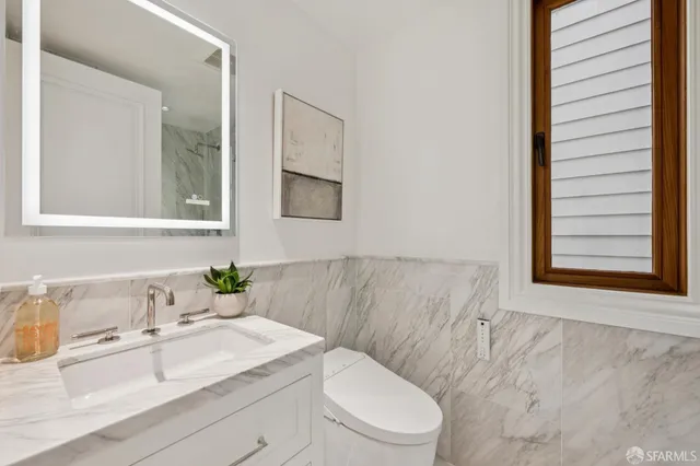 a bedroom with a large bed and a potted plant