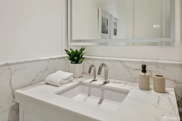 a bathroom with a sink and mirror