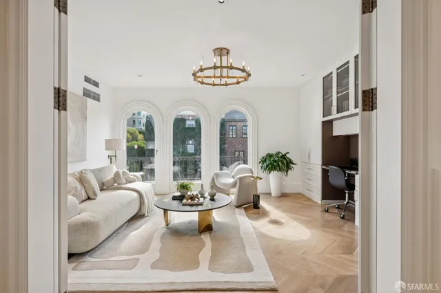 a living room with furniture and a wooden floor