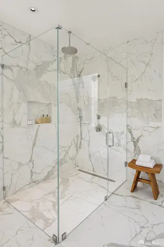 a living room with furniture kitchen view and a window