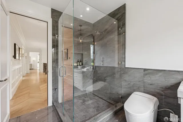 a bathroom with a granite countertop sink mirror vanity and toilet