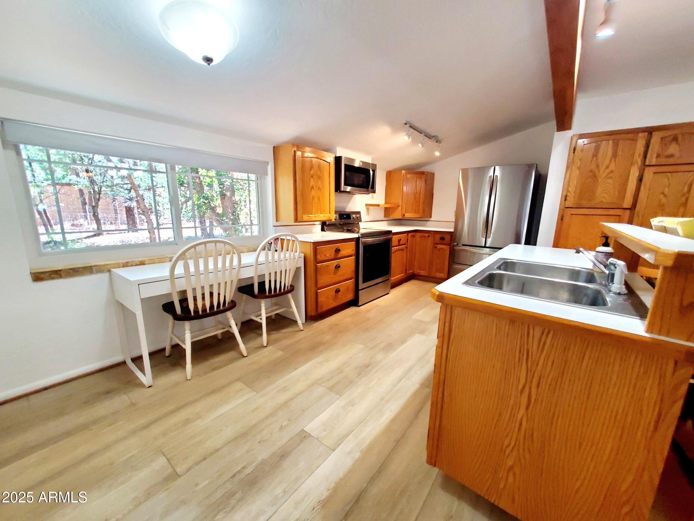 8449 Elk Road Pine, AZ 85544 - Photo 11 of 24 a living room with stainless steel appliances furniture and a wooden floor