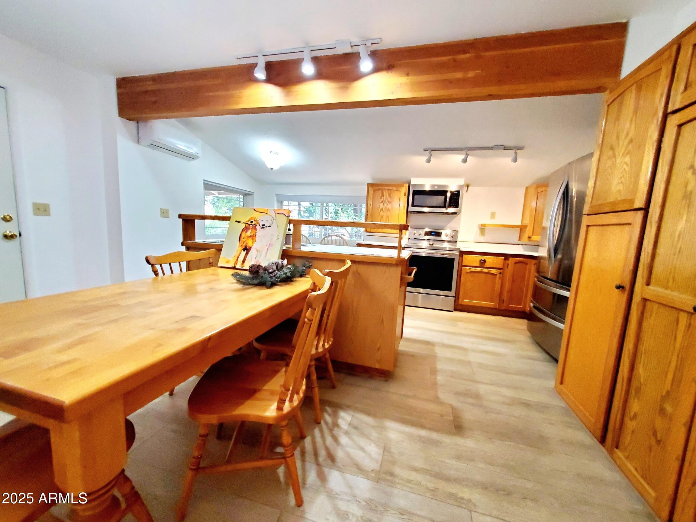 8449 Elk Road Pine, AZ 85544 - Photo 13 of 24 a dining table chairs in a kitchen next to a window