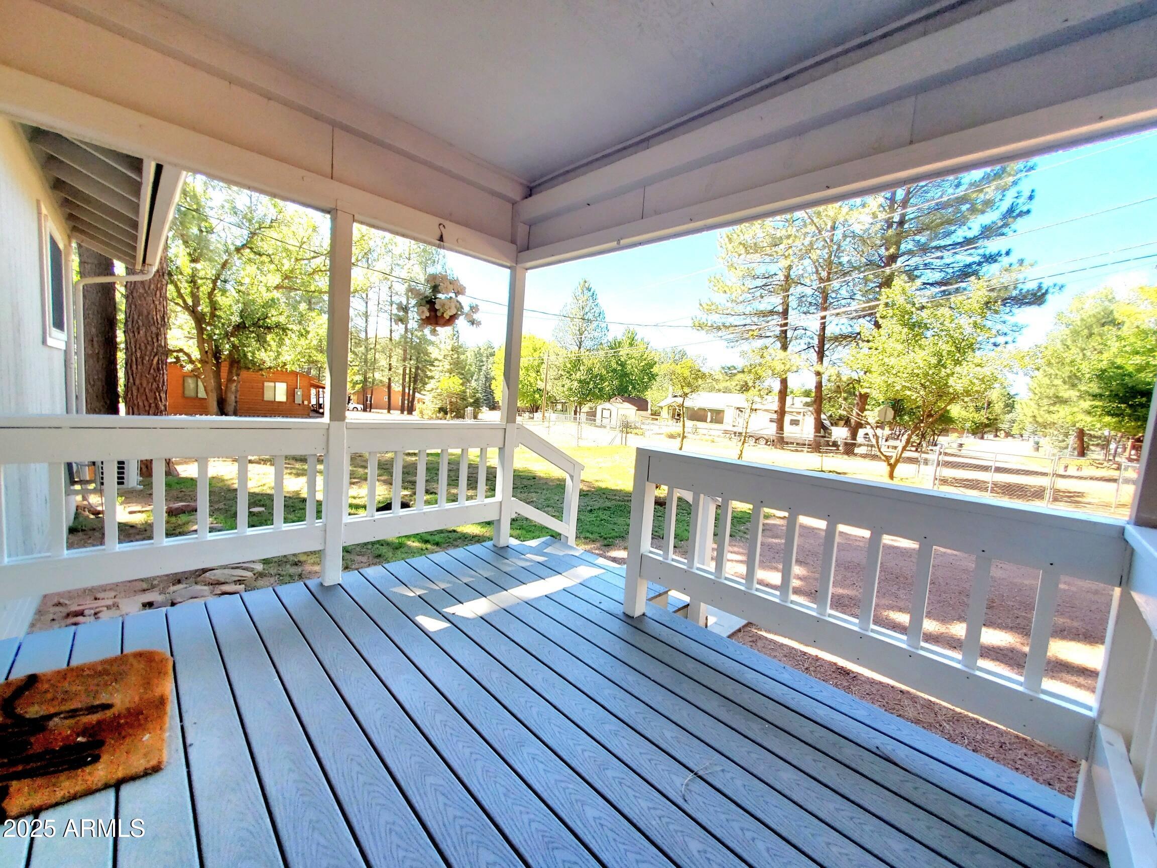 8449 Elk Road Pine, AZ 85544 - Photo 24 of 24 a room with wooden floor and furniture on wooden floor