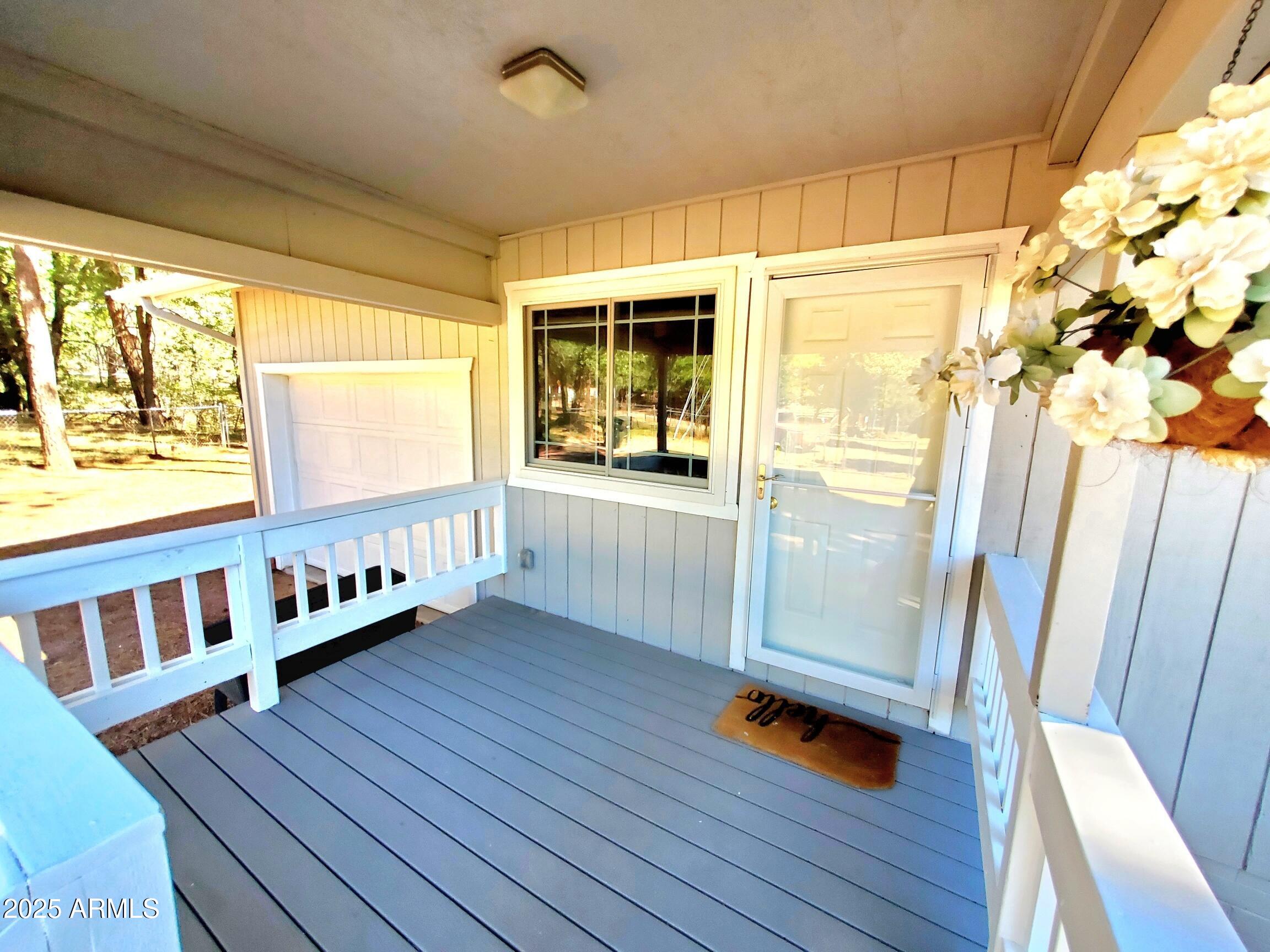 8449 Elk Road Pine, AZ 85544 - Photo 6 of 24 a hallway with wooden floor and iron stairs