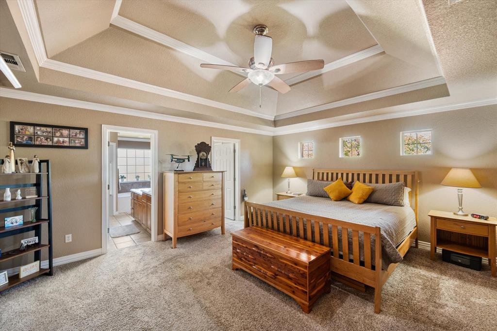 3600 Doris Walker Trail Burleson, TX 76028 - Photo 15 of 40 a bedroom with bed and a chandelier