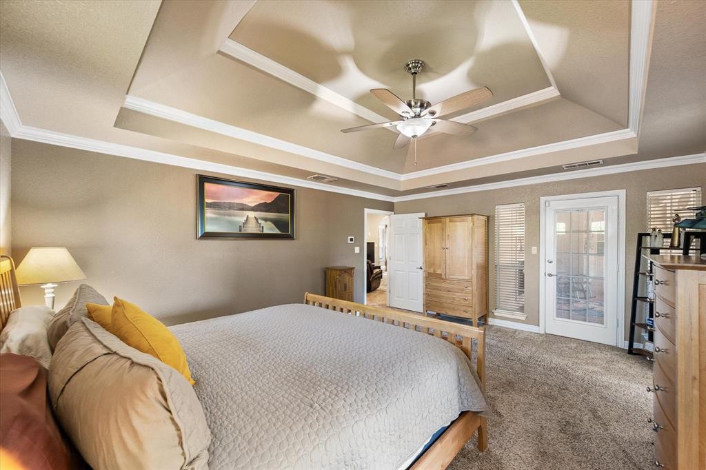 3600 Doris Walker Trail Burleson, TX 76028 - Photo 16 of 40 a bedroom with a large bed and a chandelier