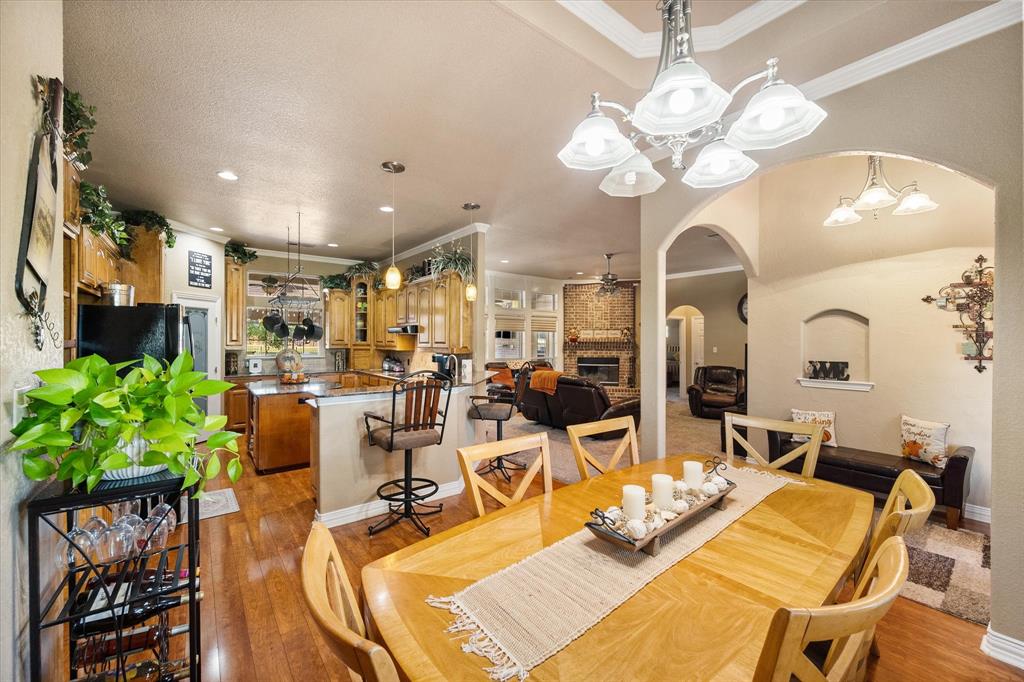 3600 Doris Walker Trail Burleson, TX 76028 - Photo 6 of 40 a view of a dining room with furniture a potted plant and wooden floor