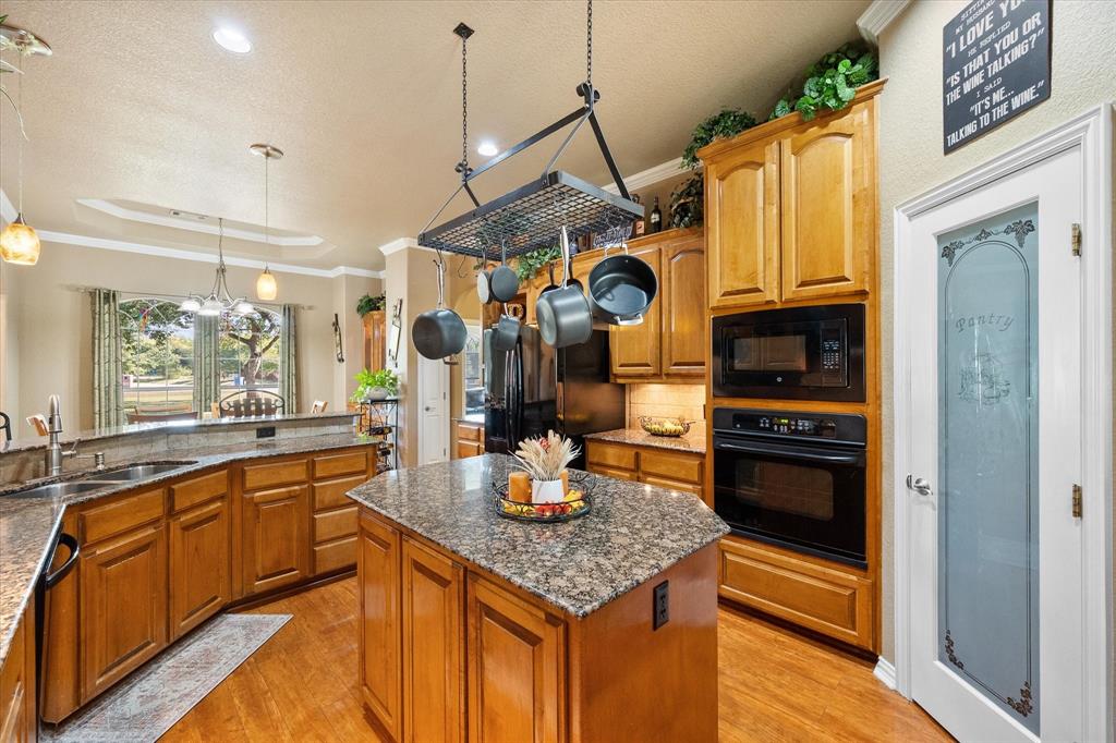 3600 Doris Walker Trail Burleson, TX 76028 - Photo 8 of 40 a kitchen with stainless steel appliances granite countertop a sink a stove and a refrigerator