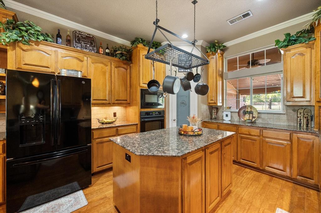 3600 Doris Walker Trail Burleson, TX 76028 - Photo 10 of 40 a kitchen with stainless steel appliances granite countertop a refrigerator a sink and dishwasher