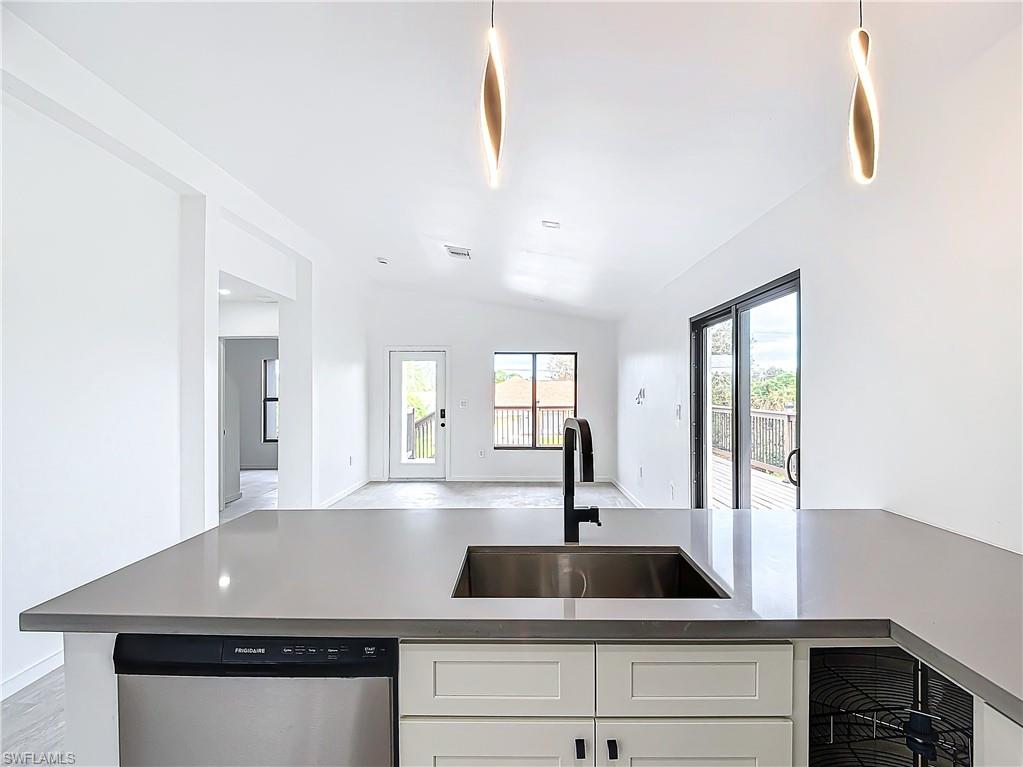 3710 10th Street Southwest Lehigh Acres, FL 33976 - Photo 13 of 30 a kitchen with a granite countertop sink and a window