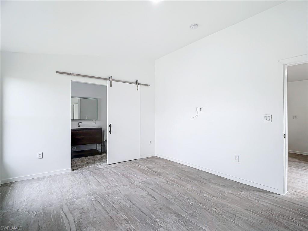 3710 10th Street Southwest Lehigh Acres, FL 33976 - Photo 18 of 30 a view of empty room with wooden floor