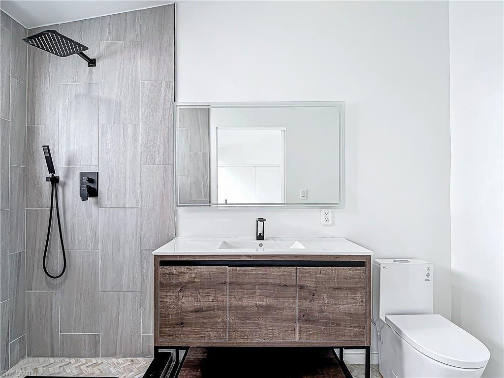 3710 10th Street Southwest Lehigh Acres, FL 33976 - Photo 19 of 30 a bathroom with a sink toilet and shower