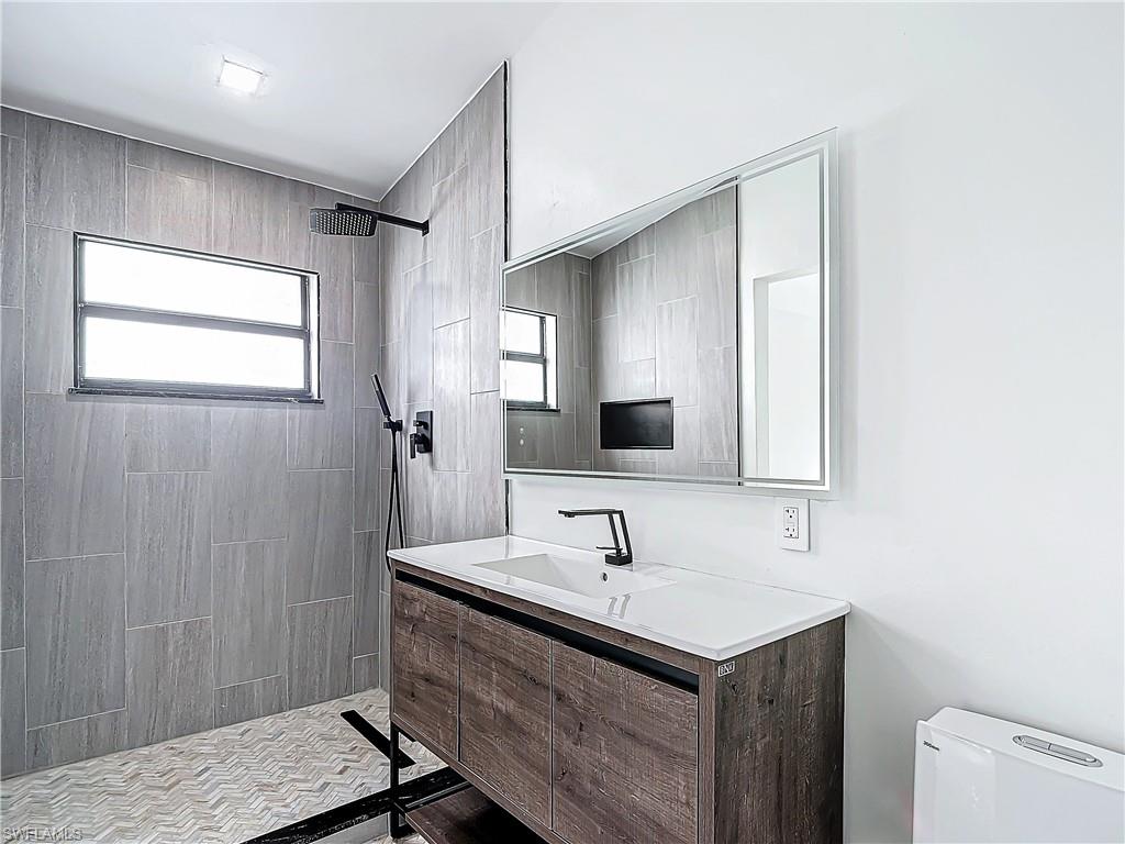 3710 10th Street Southwest Lehigh Acres, FL 33976 - Photo 21 of 30 a bathroom with a sink and a mirror