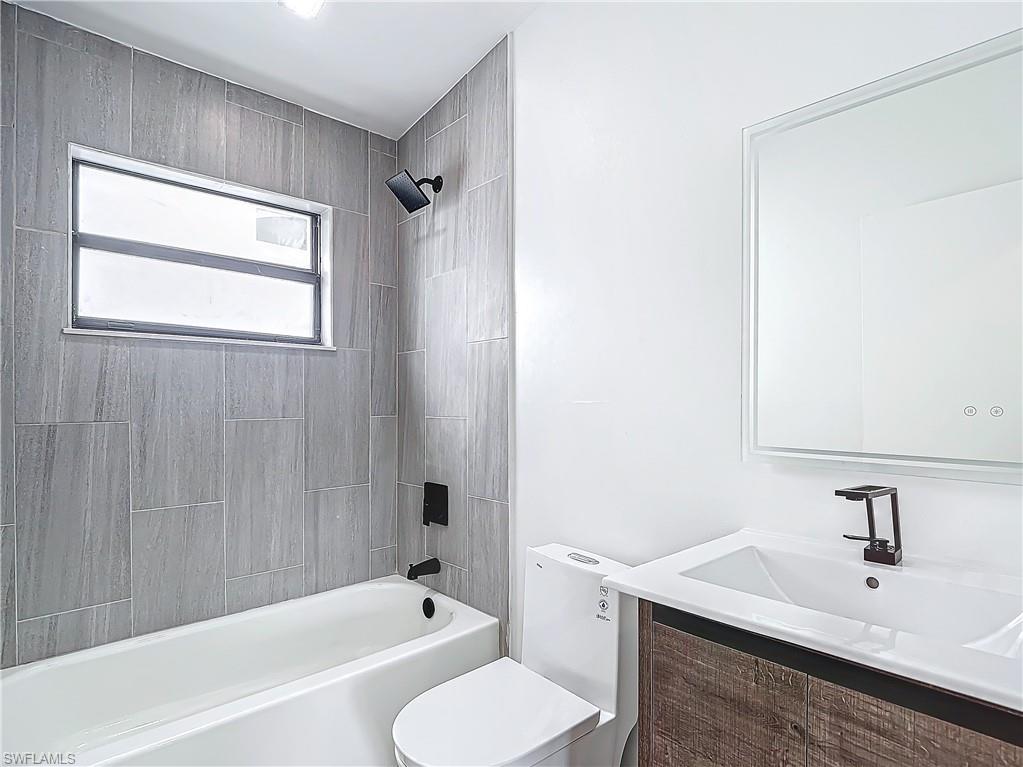 3710 10th Street Southwest Lehigh Acres, FL 33976 - Photo 27 of 30 a bathroom with a sink toilet and shower