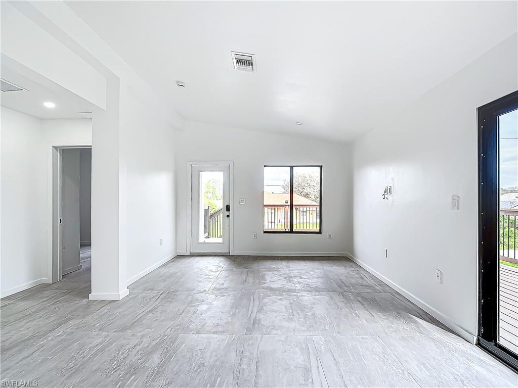 3710 10th Street Southwest Lehigh Acres, FL 33976 - Photo 7 of 30 an empty room with wooden floor and windows