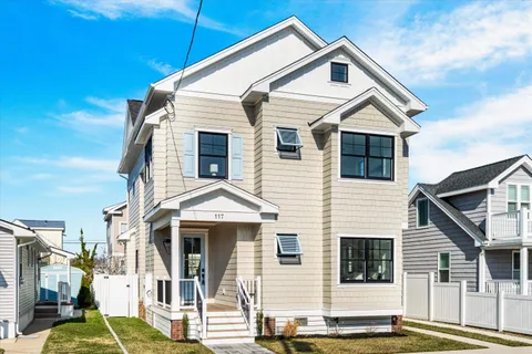 a view of a white house with large windows