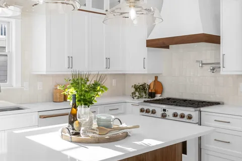 a kitchen with a stove a sink and cabinets