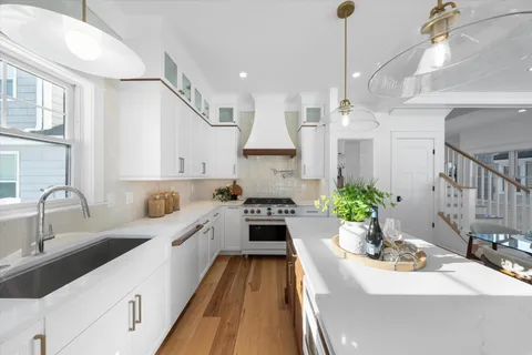 a kitchen with sink stove and cabinets