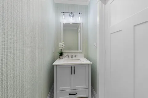 a bathroom with a sink a toilet and mirror