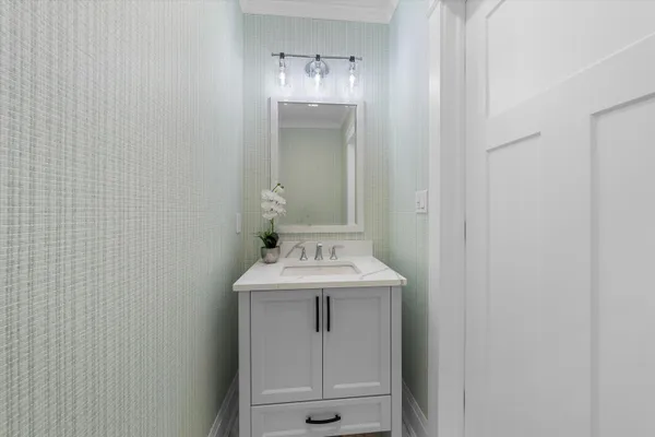 a bathroom with a sink a toilet and mirror