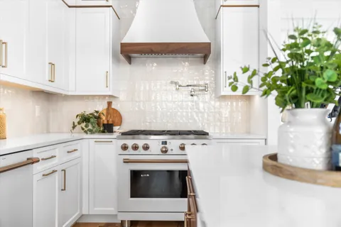 a white stove top oven sitting inside of a kitchen