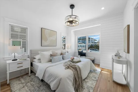 a bedroom with a bed and a chandelier