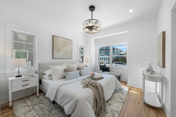a bedroom with a bed and a chandelier