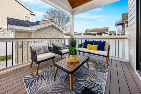 a terrace with outdoor seating and wooden floor