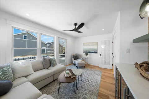 a living room with furniture and a large window