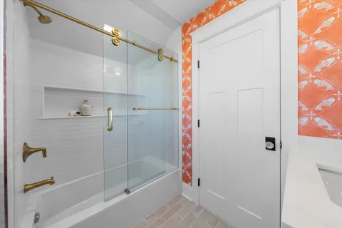 a bathroom with a bathtub and a shower
